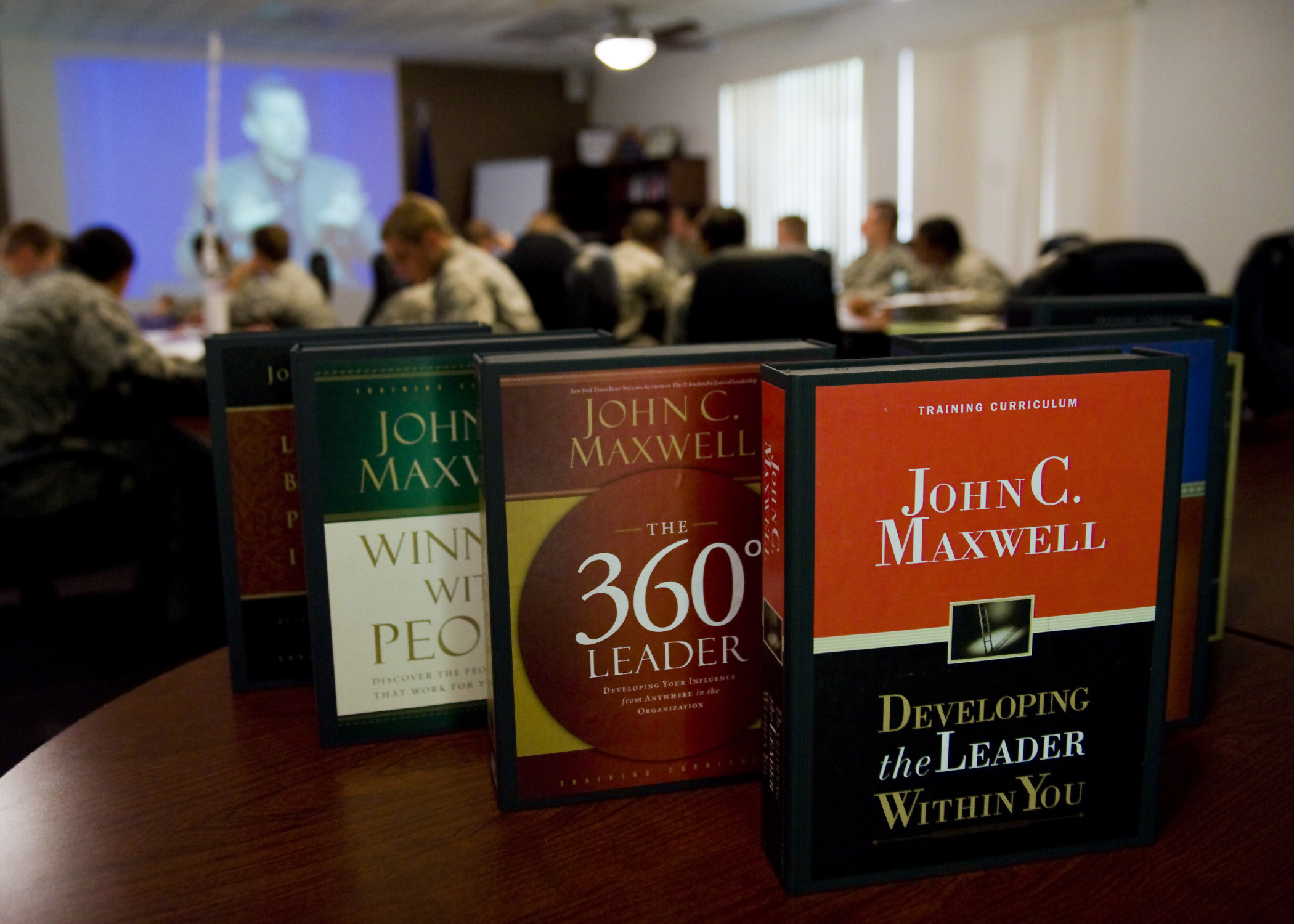 Students from Class 11-Y of the First Term Airman Course watch a DVD featuring John C. Maxwell, author of "Developing the Leader Within You," during a Lunch N' Lead Seminar on Aug. 24, 2011 at the Professional Development Center, on Nellis Air Force Base, Nev. Lunch N' Lead Seminars are designed for airmen, first time supervisors, and experienced supervisors who want to improve their leadership skills. Maxwell will be speaking at future seminars here at Nellis AFB. Supervisors are encouraged to bring at least one subordinate with them to this training series. Individuals can attend the entire course or choose the seminars which suit their personal needs or skill levels. For more information on dates and how to sign up, contact Tech. Sgt. James Silcott, First Term Airman Course Non-commissioned Officer in Charge, at 652-2206. (U.S. Air Force photo by Airman Basic Jamie L. Nicley/Released)